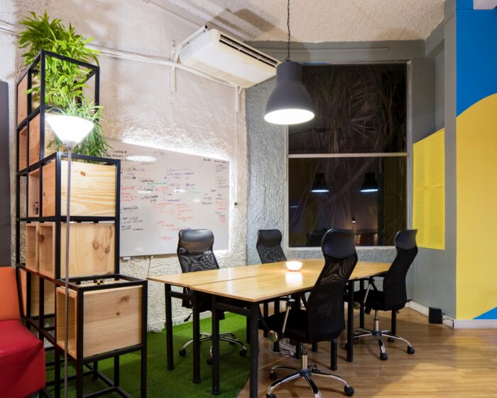 Colorful conference room design with table and chairs.