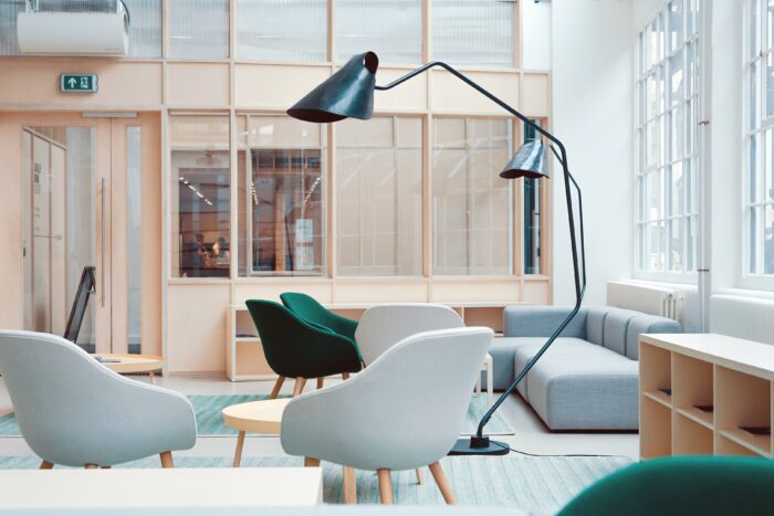 Bright employee break room with comfortable chairs and tables.