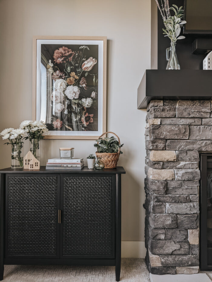 Victorian & Gothic Home Decor Guide: Dark rattan cabinet and stone pair perfectly with framed flowers.