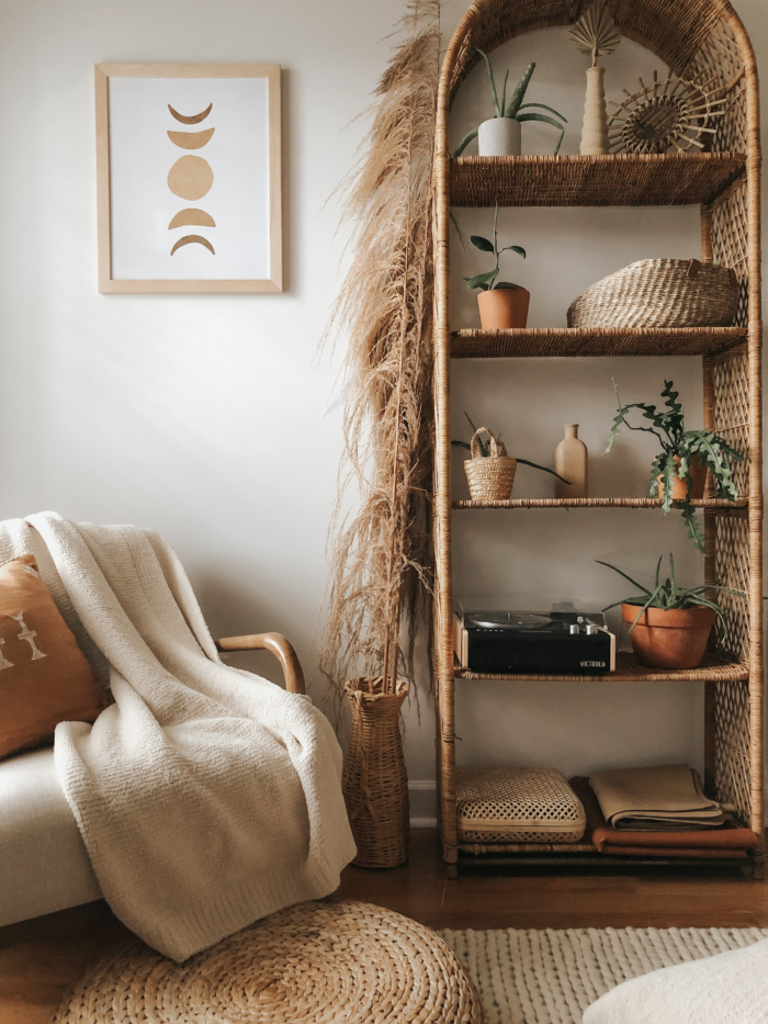 Cozy Fall Aesthetic: Bookcase and chair with a framed art print.