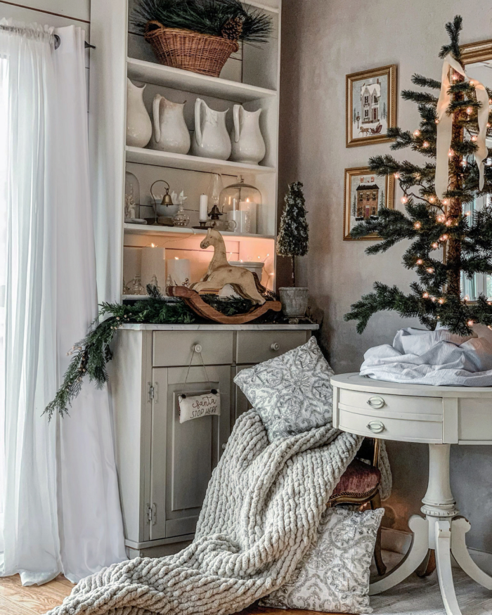 Cozy Fall Aesthetic: Framed art prints next to a bookcase in a cozy office.