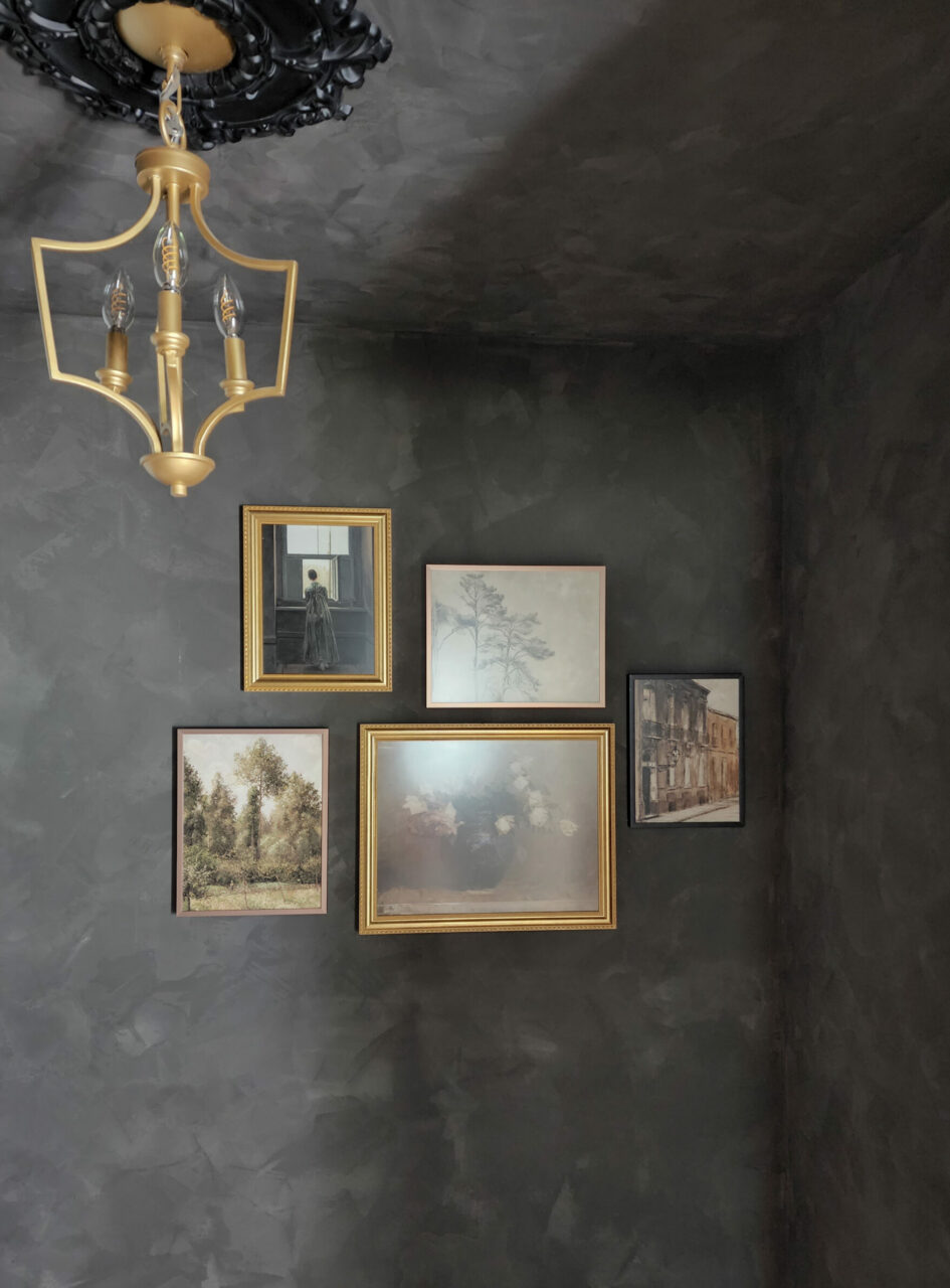 Victorian & Gothic Home Decor Guide: A dark gray wall with gallery wall photos. 
