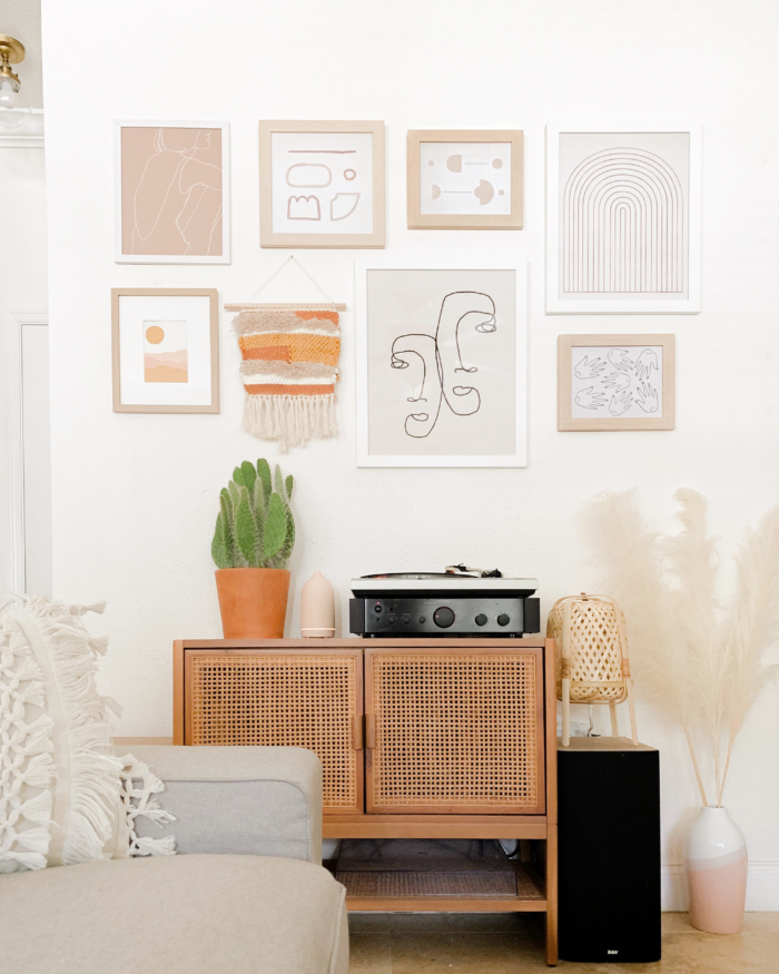 Bohemian office decor with a gallery wall and cactus.