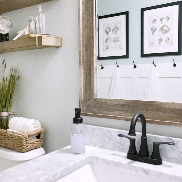 The Ultimate Renter Decor Guide: Damage Free Hanging - A clean and crisp white bathroom