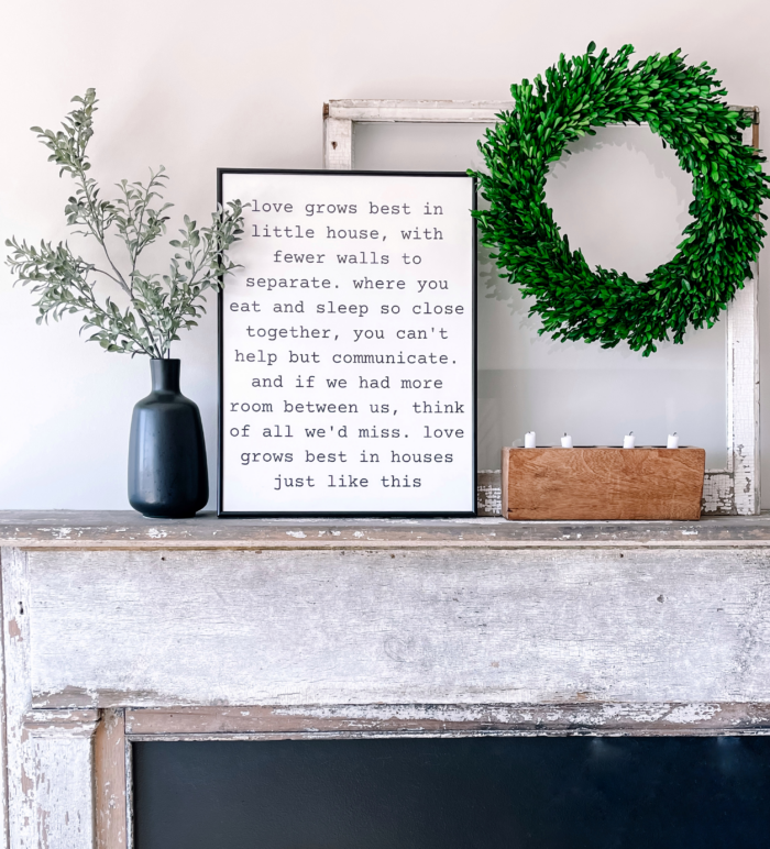 Modern farmhouse decor with framed print on a fireplace.