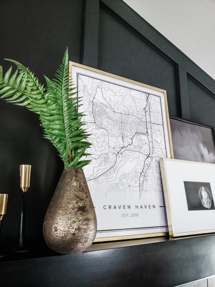 Airbnb design with dark painted wall and framed map print