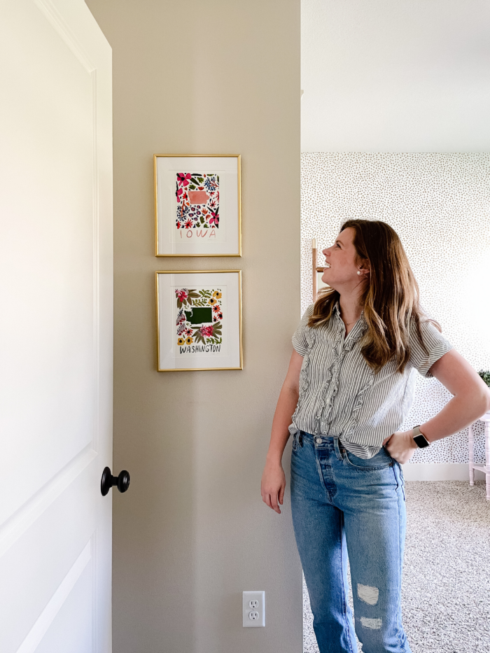 Lady admiring framed art prints.