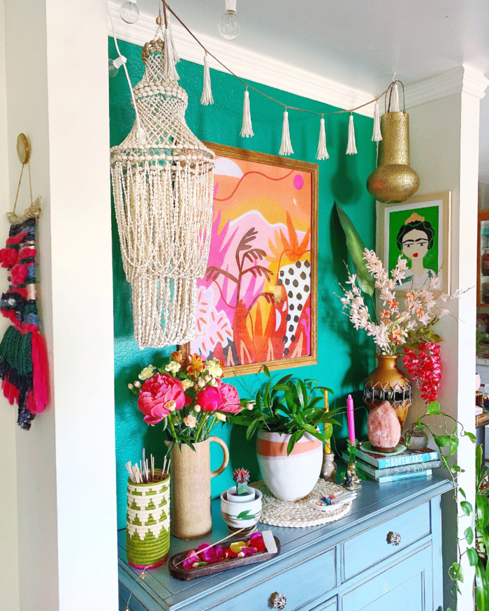Eclectic decor with an accent wall and a colorful framed art print.