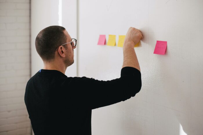 10 Creative Employee Appreciation Gift Ideas - An employee putting notes on a whiteboard.