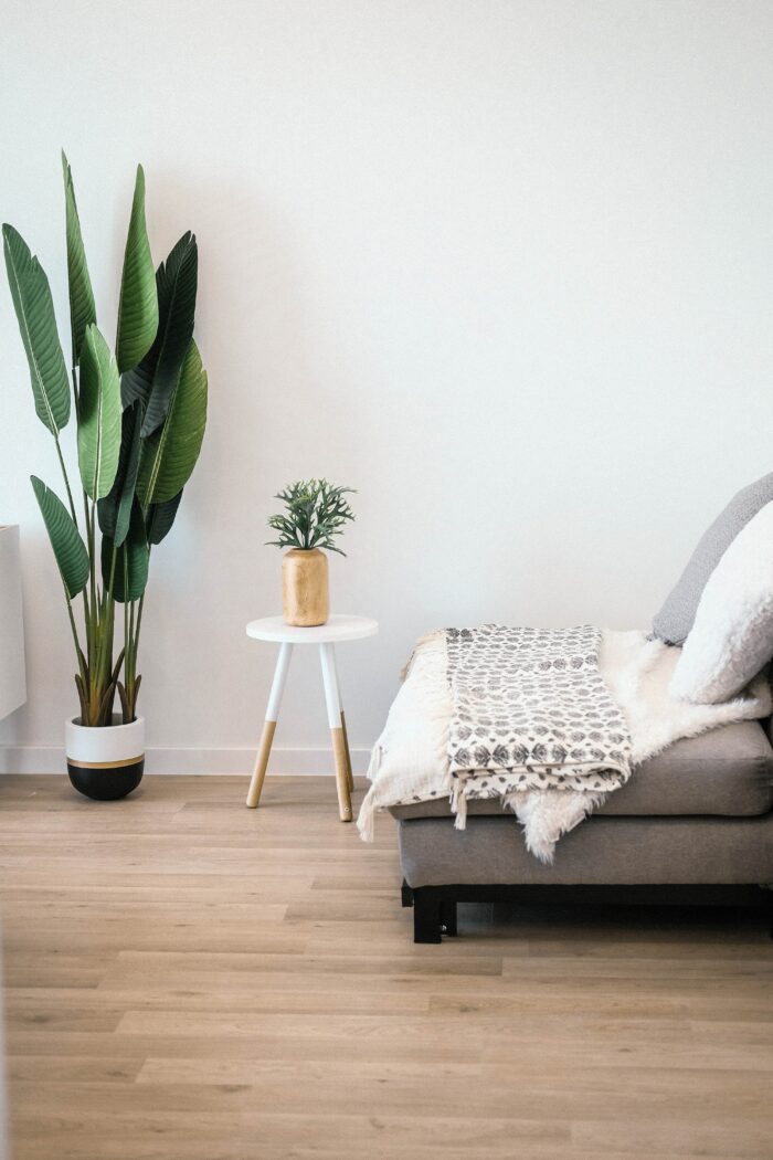 Scandinavian office decor with chair, blanket and a white table.