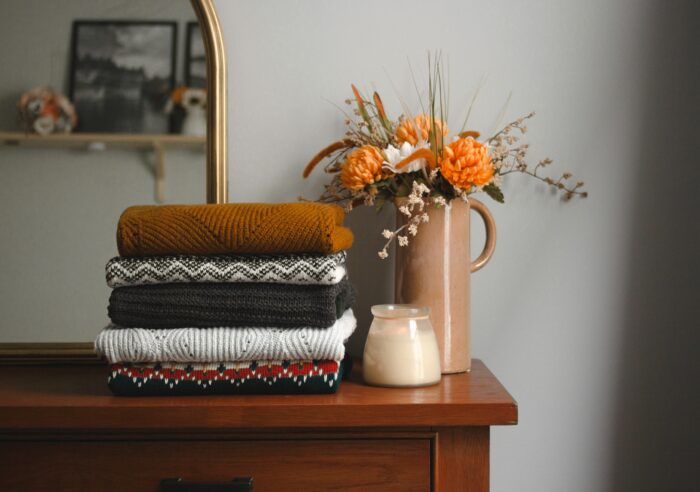 Cozy Fall Aesthetic: Blankets and candles on a table.