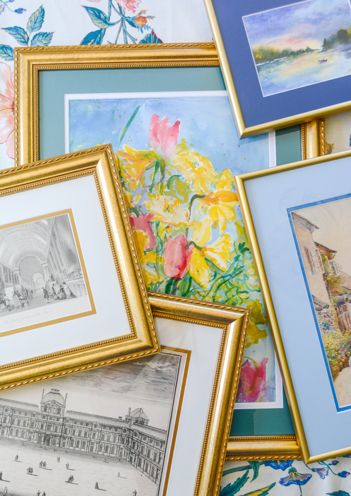 Close up of art prints in frames.