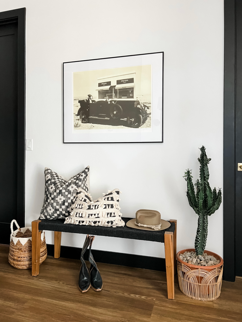 Southwestern decor with a cactus and framed vintage art print.