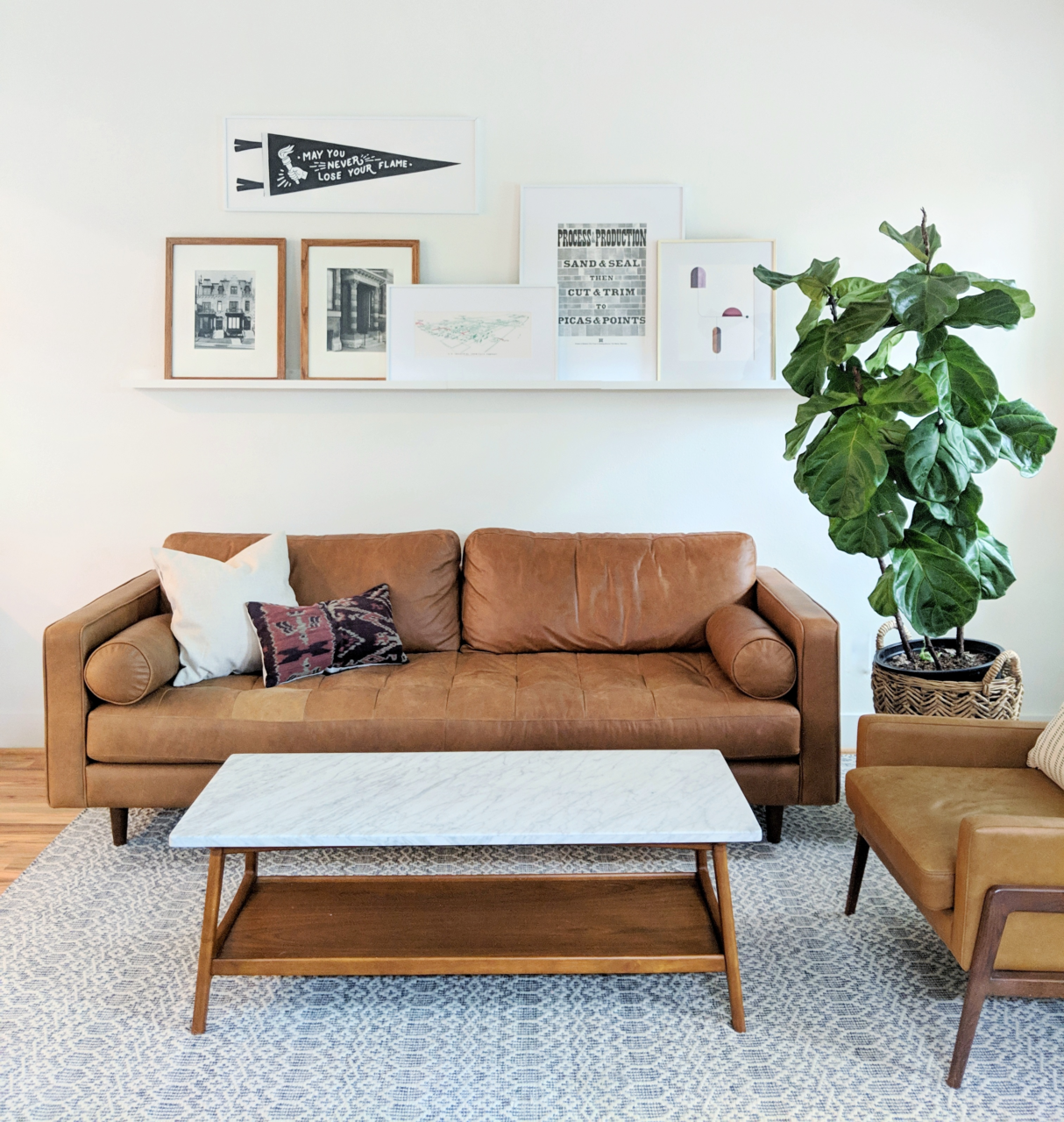 Midcentury Modern Decor Ideas: A couch with midcentury artwork above it