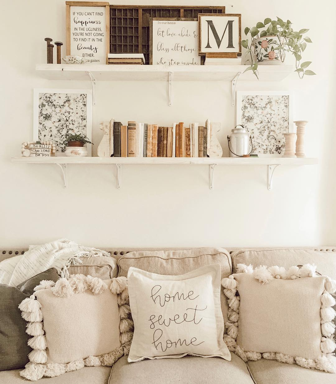 Cottagecore style decor with framed art prints above a couch.