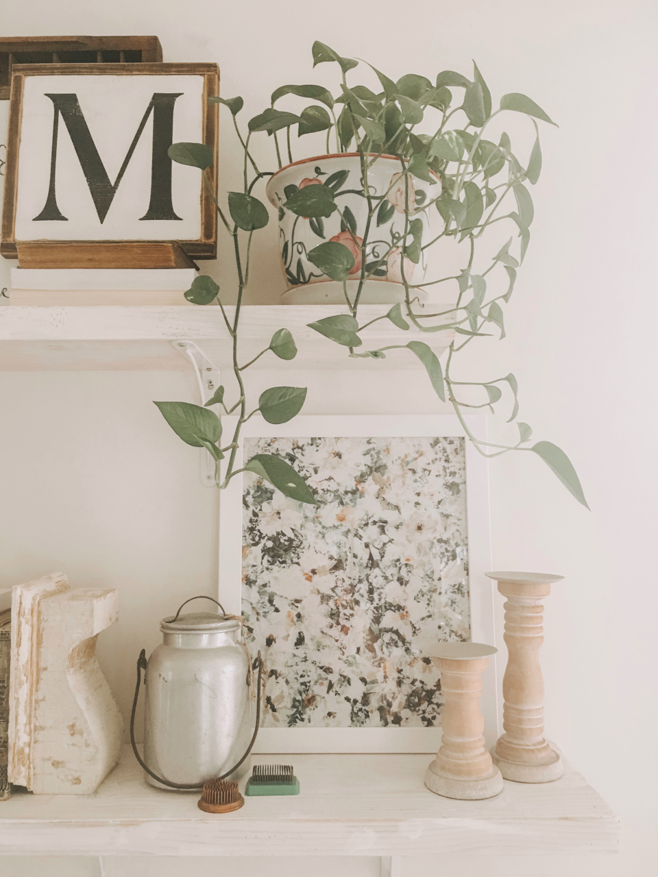 Cottagecore decor: Framed art print below a potted plant.