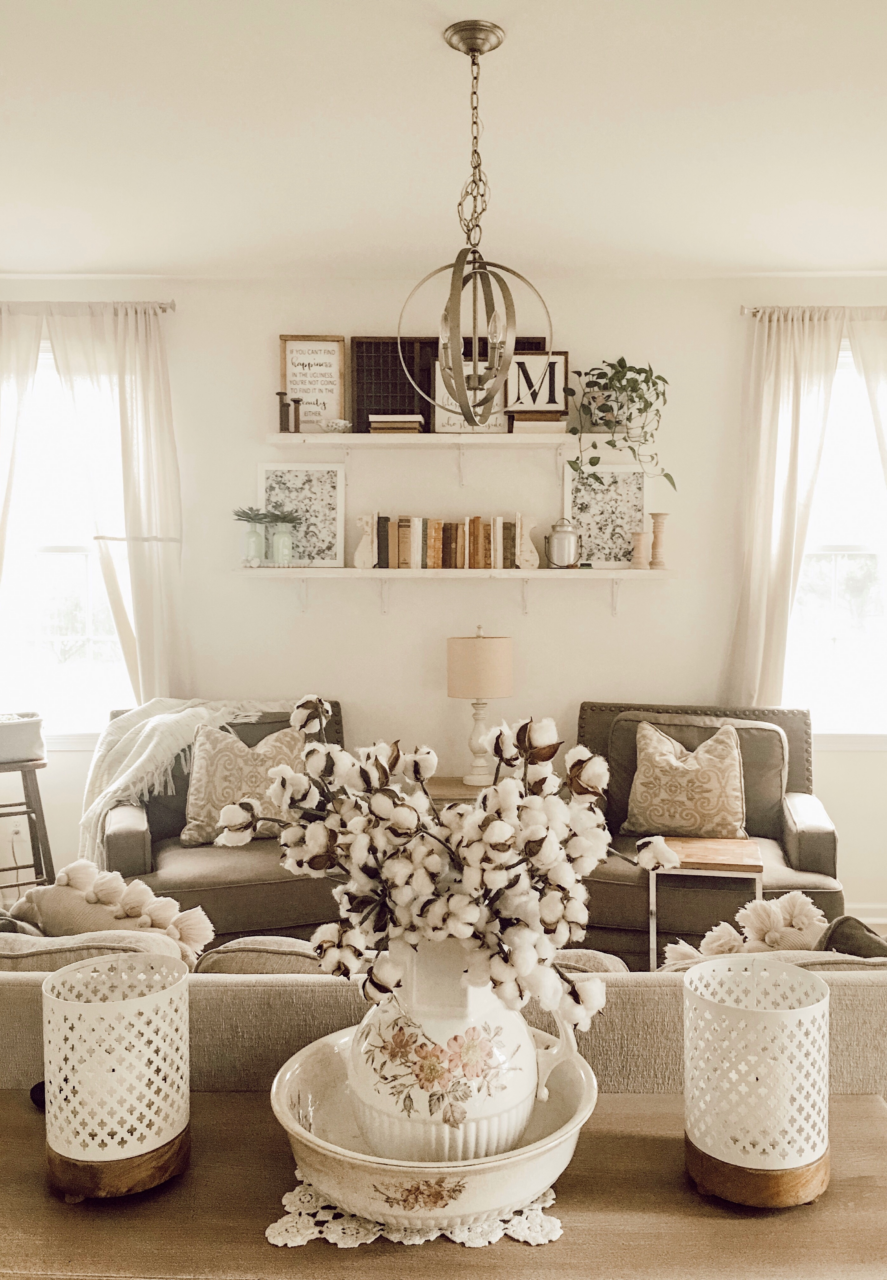 Cottagecore decor with framed art above chairs.