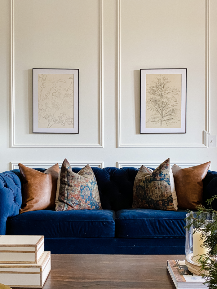 Traditional home decor with a blue couch and framed art