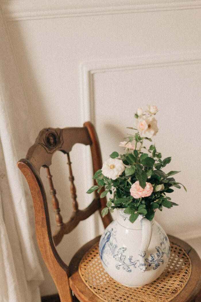 White ceramic vase with pink roses.