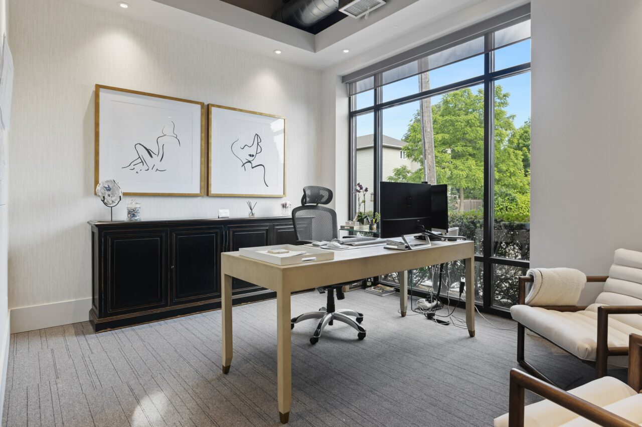 Modern office decor with framed art prints and a computer desk.