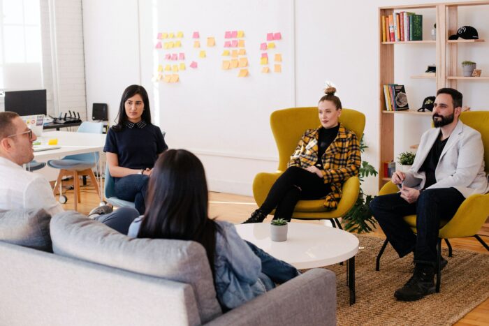 How To Design A Break Room Employees Will Love 1 Group of employees enjoying a break room at work.