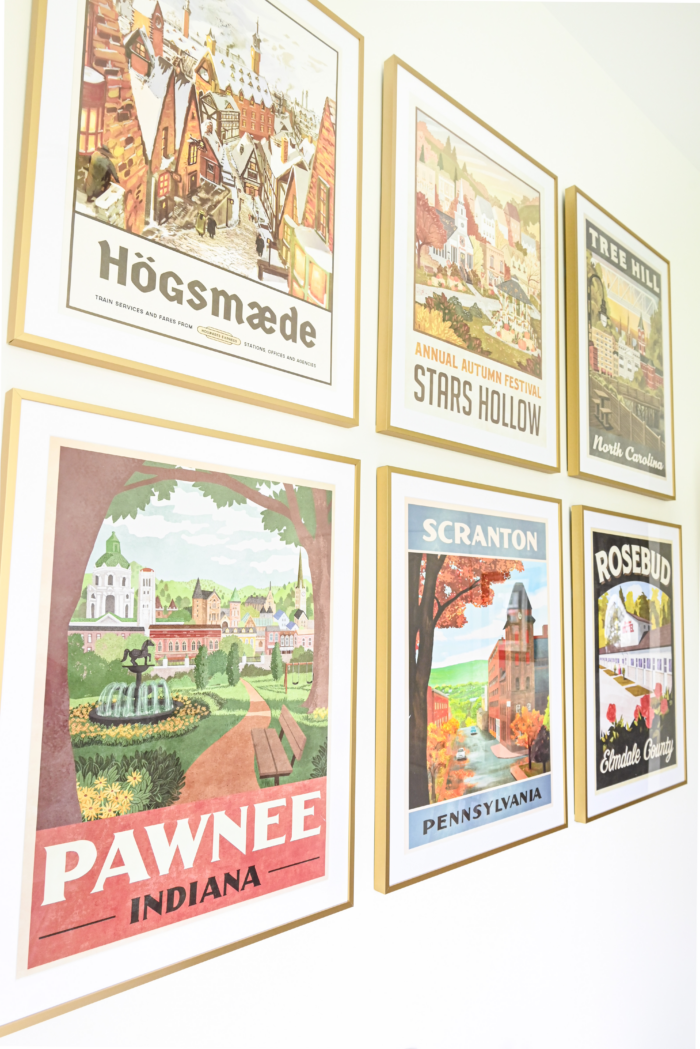 Colorful framed art prints on a gallery wall.