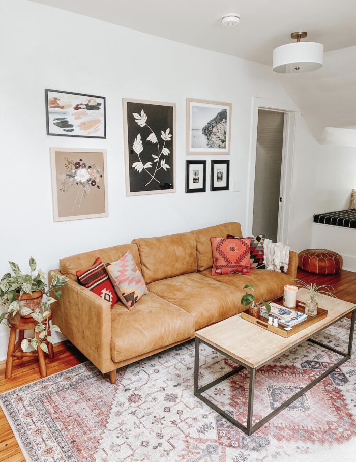 Alternative Living & Functional Framing: a modern boho-styled living room with a staggered gallery wall. 
