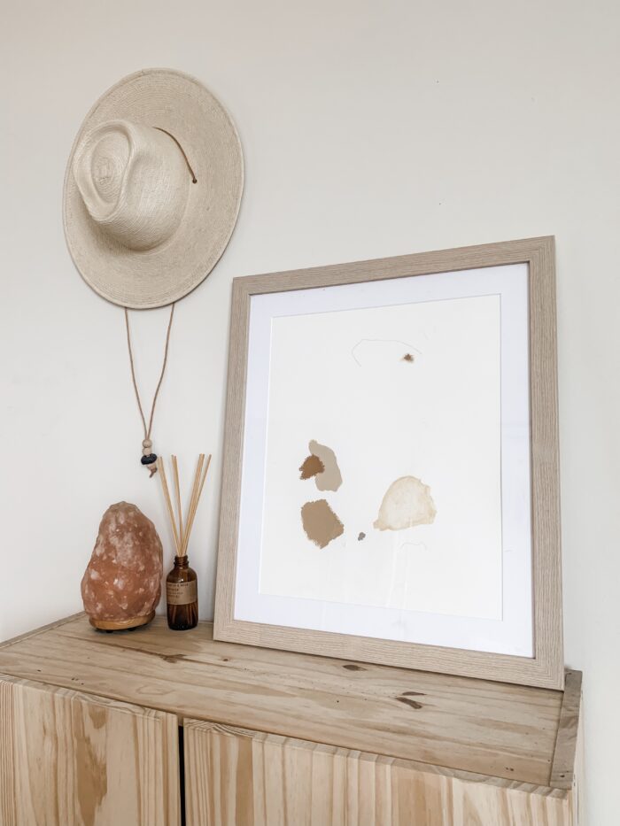 Alternative Living & Functional Framing:
A minimalist-styled bedroom dresser with tabletop displayed framed print. 