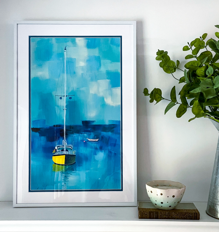 Framed painting of a yellow boat.