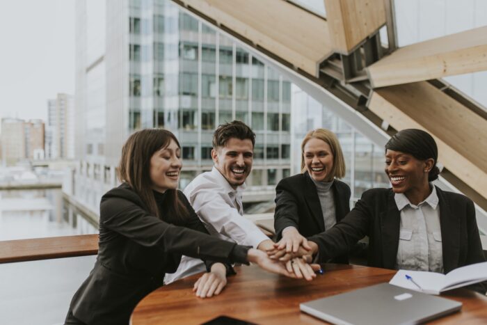 Coworking Space Design 101: Best Decor Tips For Shared Workspaces: Business colleagues united hands, teamwork photo