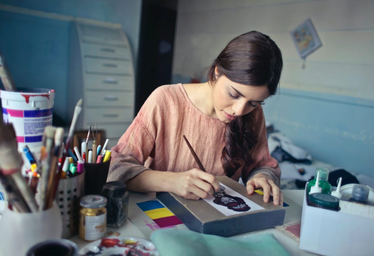 Promote Your Creative Work:An artist painting in her studio