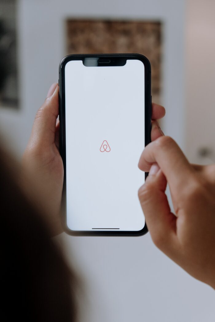 Genius Airbnb Design Tips: Cellphone displaying the Airbnb logo