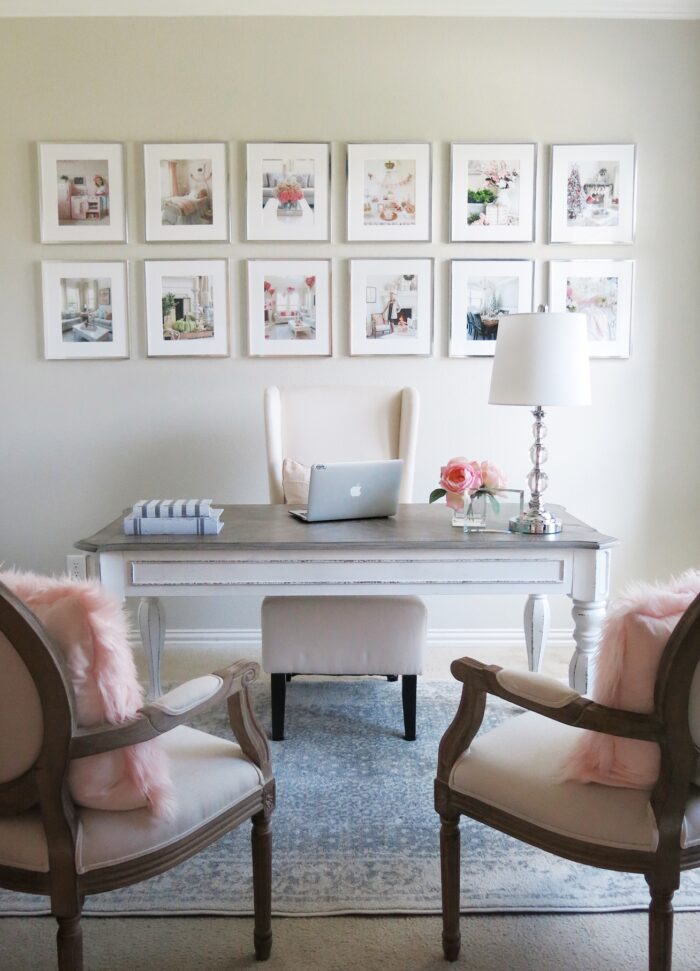 An office with framed art prints above a desk