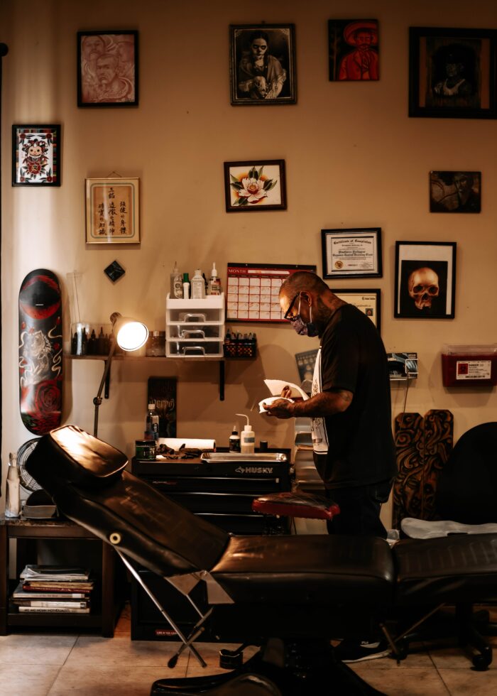 Terrific Tattoo Shop Decor & Framing For Flash Art: An artist setting up for their next client. 