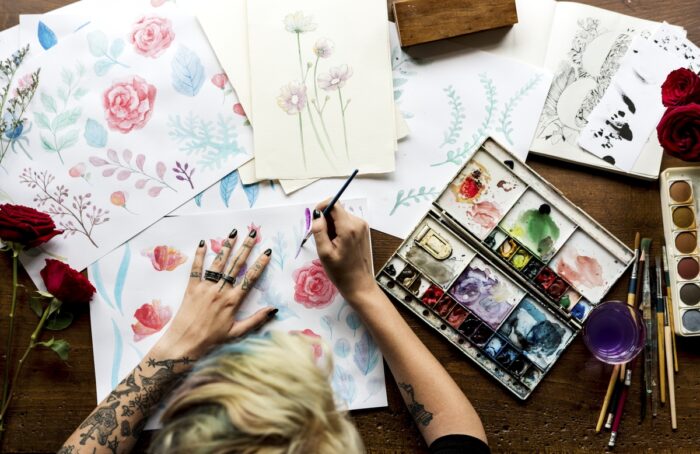 selling art on Etsy: A lady painting flowers