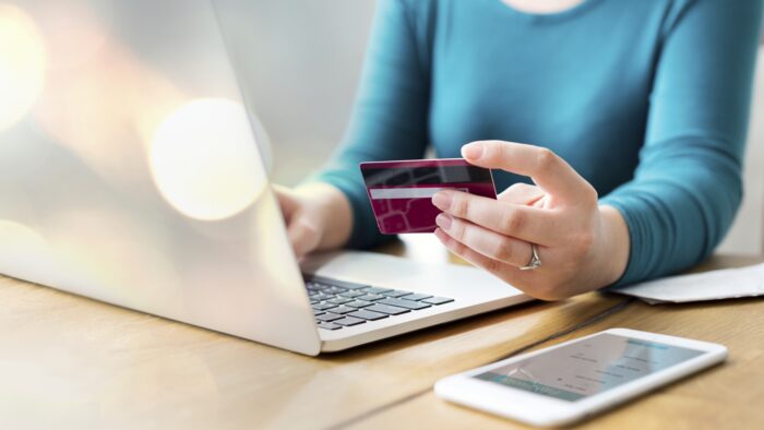 A woman paying online shopping with her card