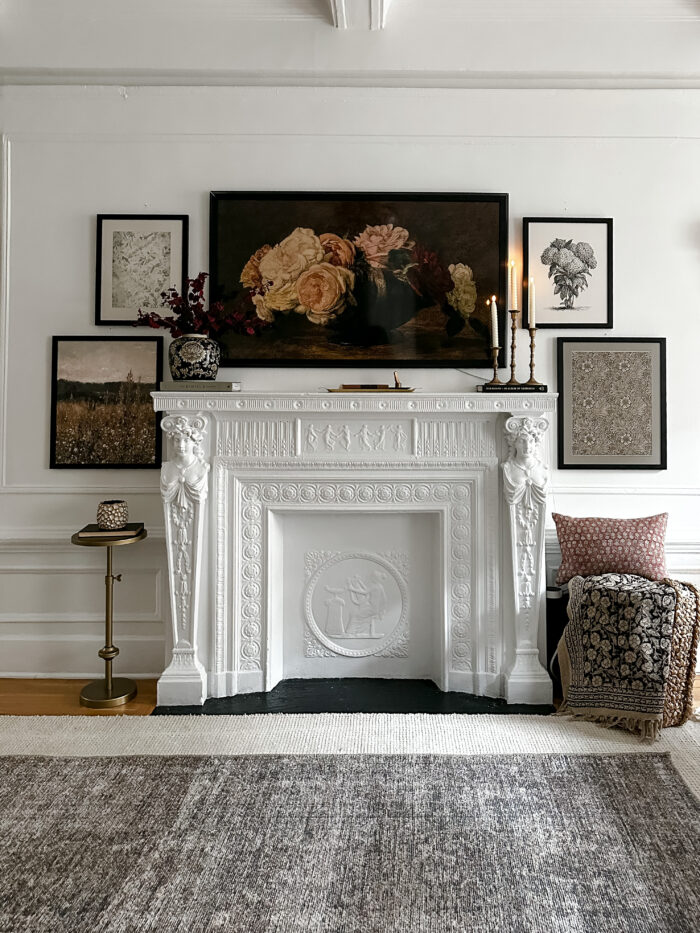 Framed art prints above a fireplace