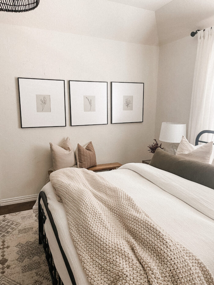 Level Framing: A minimalistic bedroom with framed art.