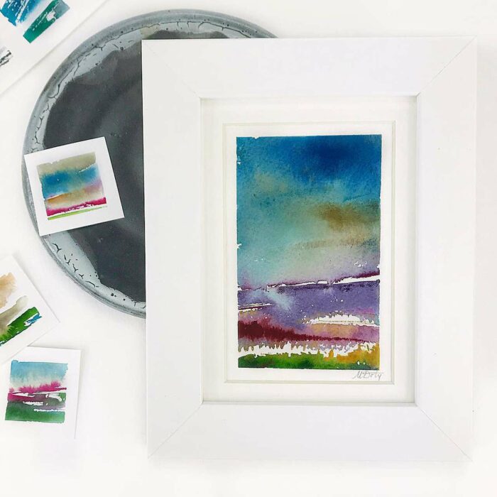 White picture frames with small watercolor art prints