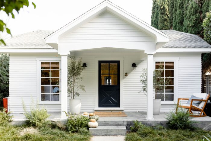 Real estate pictures of a front porch on a white house 