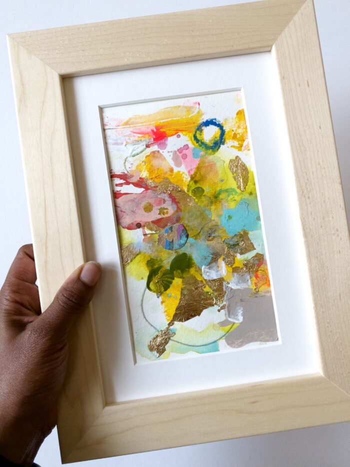Hand holding a framed art print