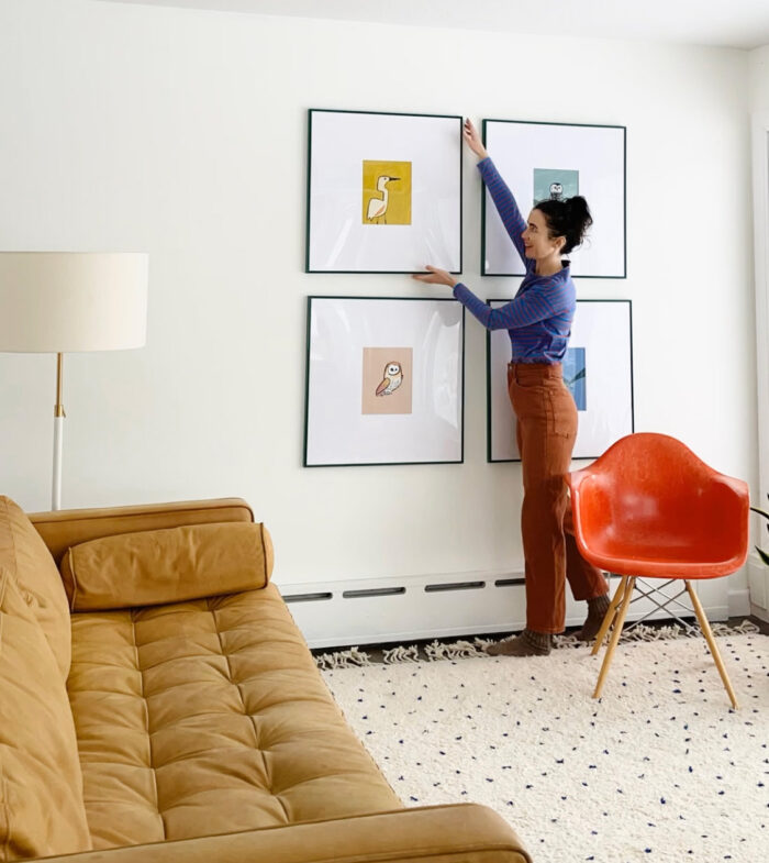 Gallery Show & Art Fair Framing: An artist hanging her illustrative works. 