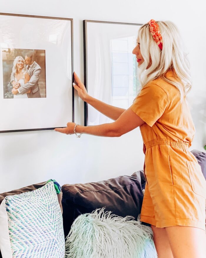 Hanging frames over a living room sofa. 