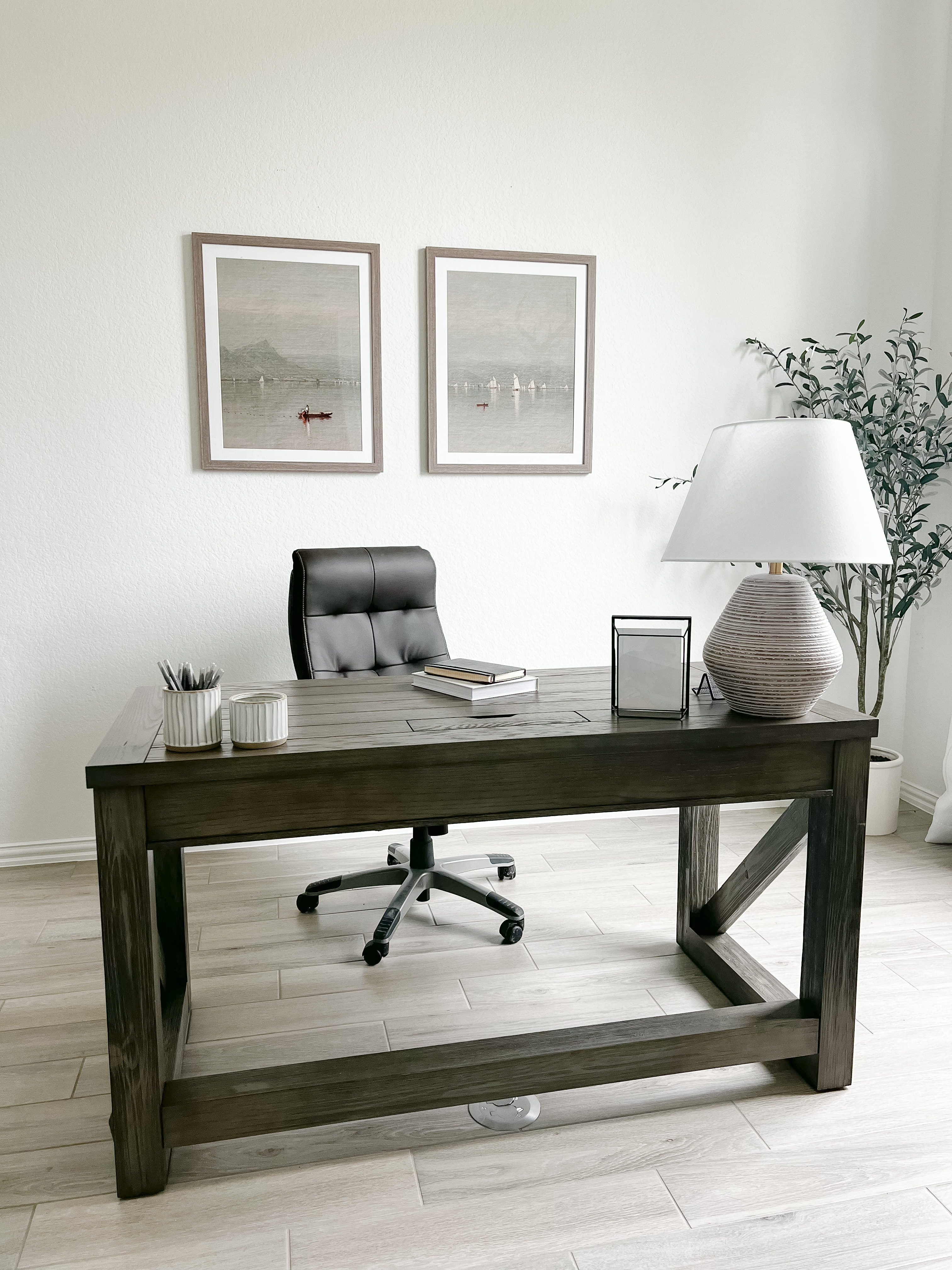 A minimalistic style office with two frames.