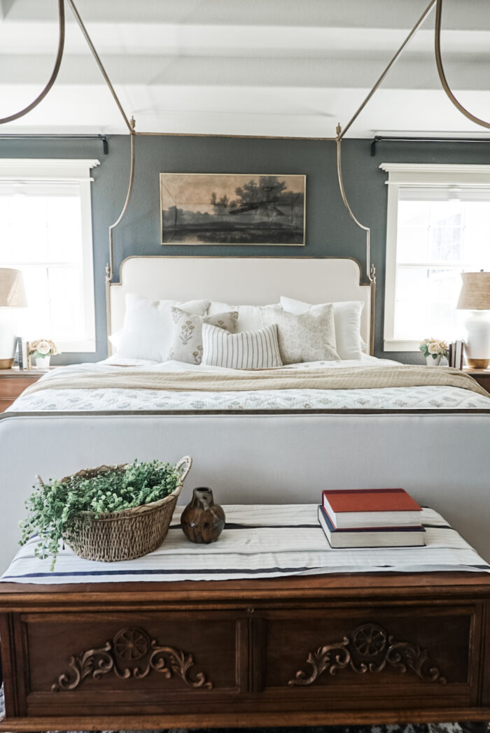 A bedroom with a single large artwork and frame.