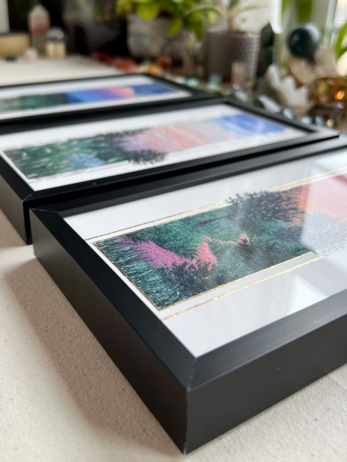 Black picture frames with colorful artwork