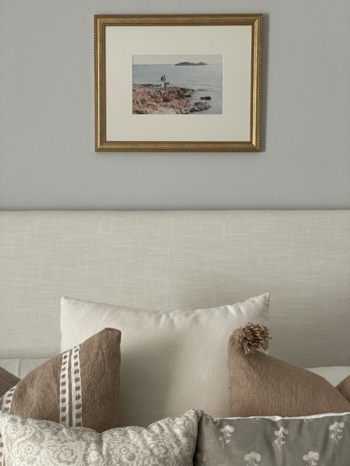Creating A Frame It Easy Customer Account: A minimalistic bedroom with a single piece of framed art 