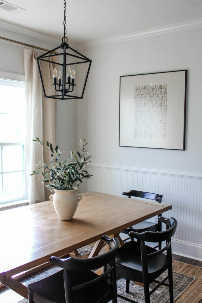Save Money on Custom Framing: A framed art print hung in a dining room. 