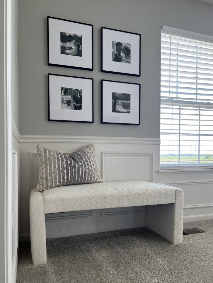Save Money on Custom Framing: Framed black and white photos hung over a bench. 