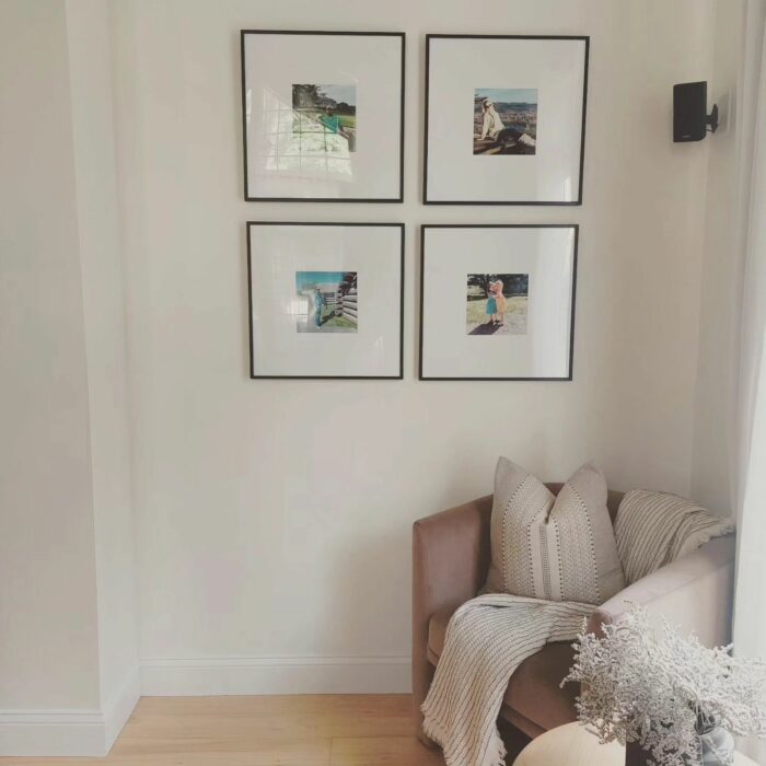 Save Money on Custom Framing: Scenic photos hung on a living room wall. 